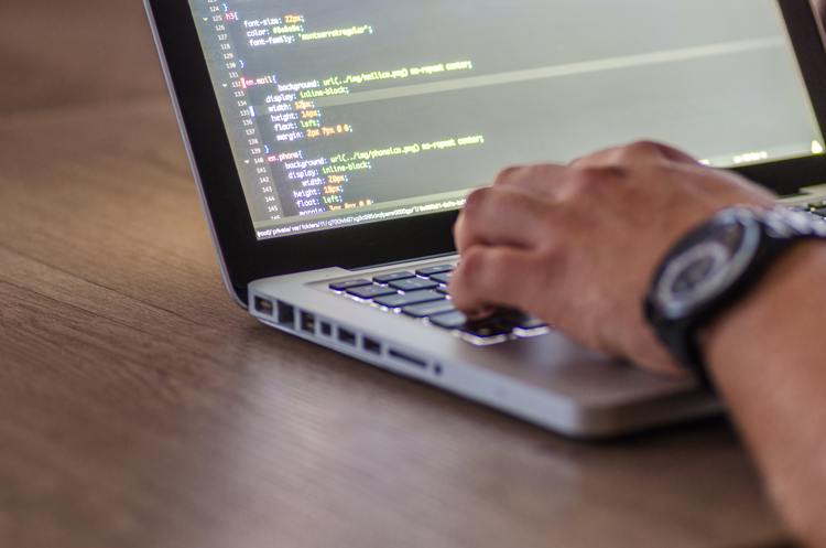 a man coding on a computer